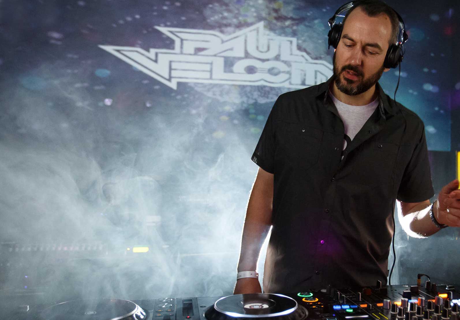 Image of DJ Paul Velocity in a nightclub behind the decks
